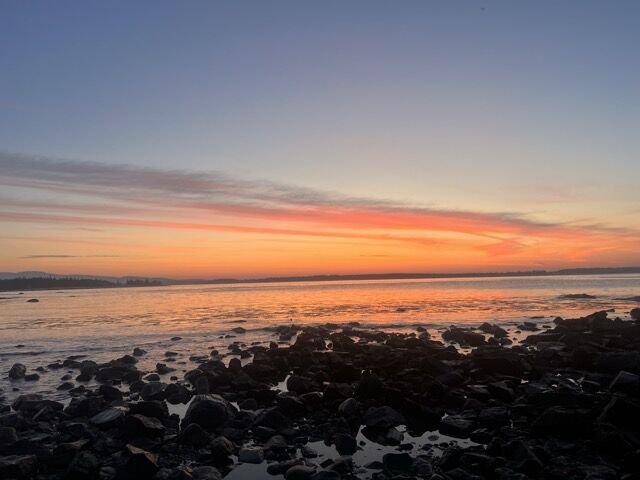 Sunrise over a rocky shoreline.