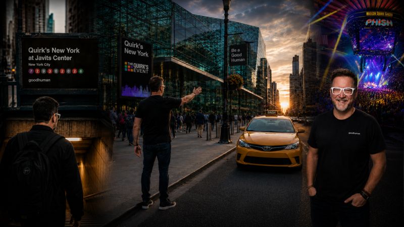 Illustration of AJ Keirans in a black goodhuman T-shirt on a New York street outside the Javits Center at sunset, with a sign for Quirk's New York at Javits Center and a Phish marquee in the background.